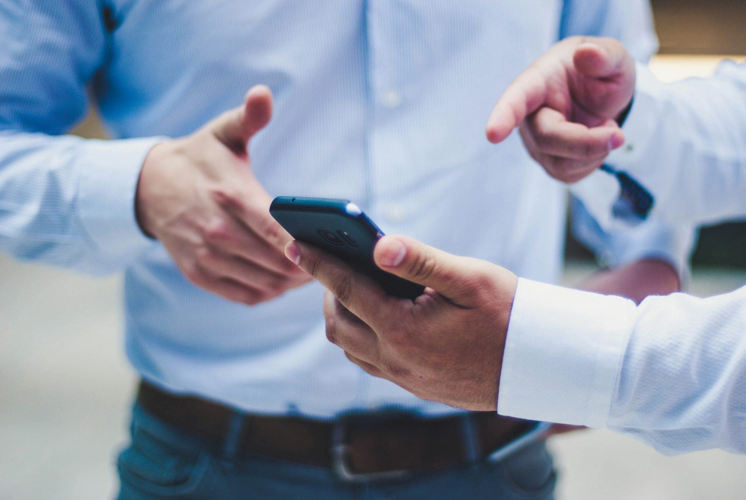 Man holding phone showing a Mobile App