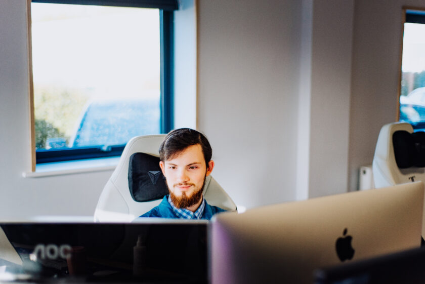 A Developer Coding with different languages at an iMac